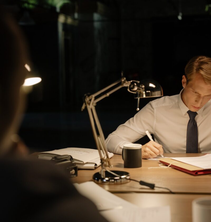 man-in-white-dress-shirt-reading-documents
